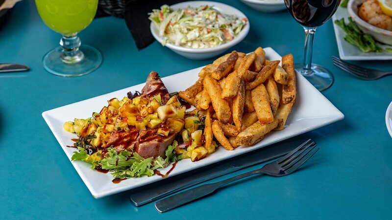 Dinner entree with side of french fries and coleslaw